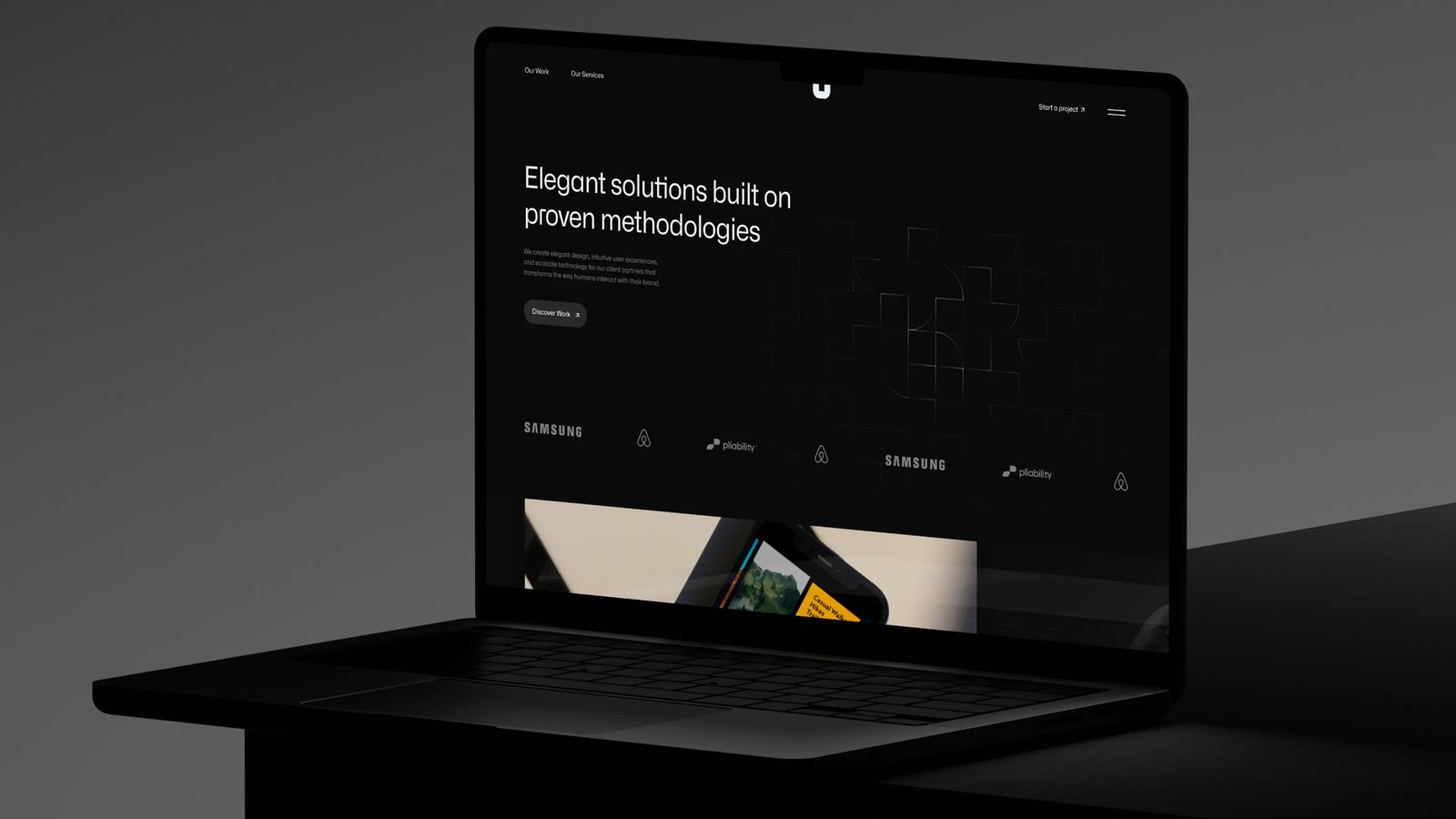 Laptop on a dark surface displaying the Utility website